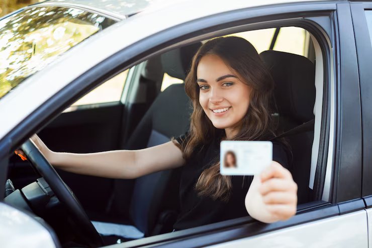 happy-student-driver-sitting-modern-silver-car-showing-driving-car-license_123211-492